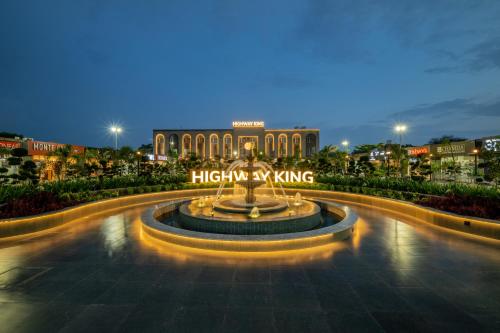 a building with a fountain in front of it at Hotel Highway King Neemrana in Neemrana