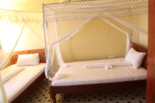 Postel nebo postele na pokoji v ubytování Pinnacle Glory Hotel