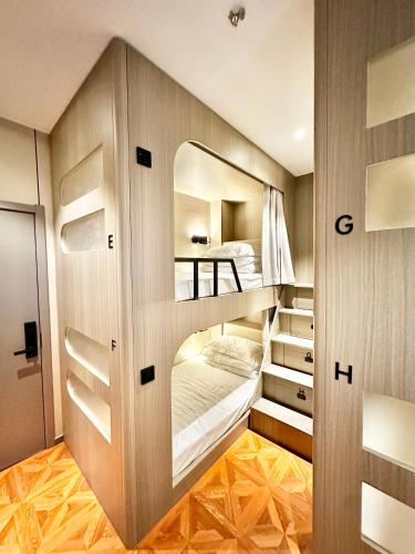 a room with two bunk beds and a mirror at Yuanjili International Youth Hostel in Qingdao