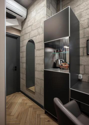 a kitchen with a black counter and a mirror at AREA Hotel Yerevan in Yerevan
