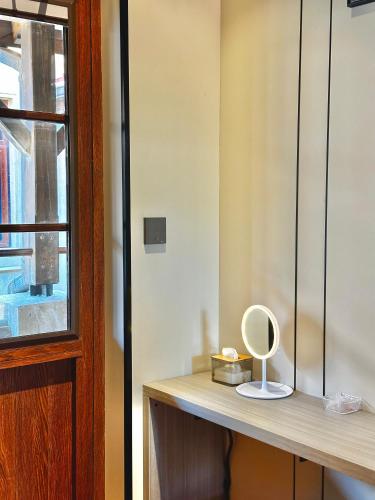 a mirror sitting on a wooden counter next to a door at Yuanjili International Youth Hostel in Qingdao