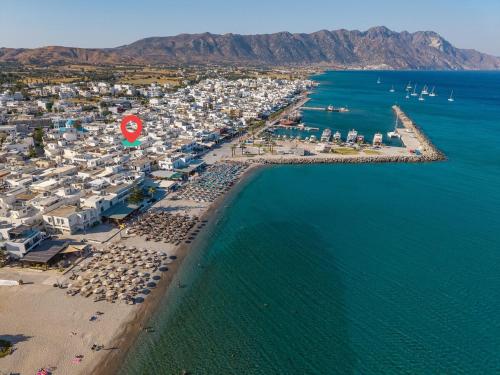 an aerial view of a beach with buildings and the water at Dafni Local Style, 1 Min from Main Beach in Kardamaina