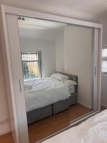 a mirror reflection of a bed in a bedroom at Modern Nest in Nelson