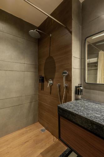 a bathroom with a sink and a shower at Hotel Highway King Neemrana in Neemrana