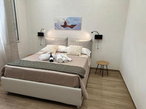 a bedroom with a bed with two stuffed animals on it at Stagnone Sunset Holidays in Marsala