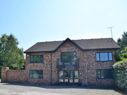 a brick house with a black roof at Lakeview House 2x Hot Tub & Games Room in York