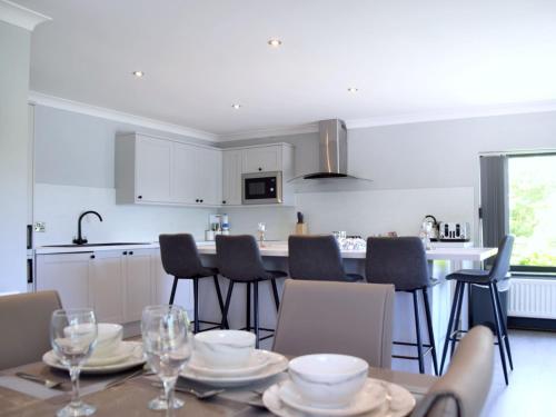 a kitchen and dining room with a table and chairs at Lakeview House 2x Hot Tub & Games Room in York