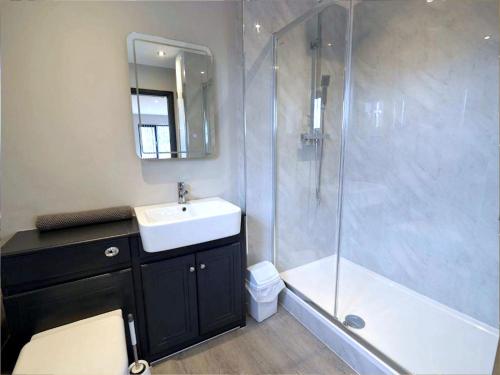a bathroom with a shower and a sink and a showerspective at Lakeview House 2x Hot Tub & Games Room in York