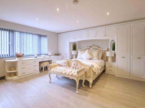 a bedroom with a large bed and a desk at Lakeview House 2x Hot Tub & Games Room in York