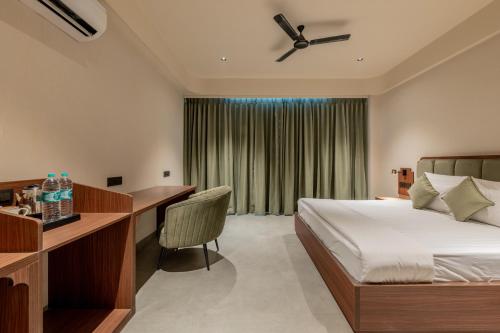 a hotel room with a bed and a desk at Hotel Highway King Neemrana in Neemrana