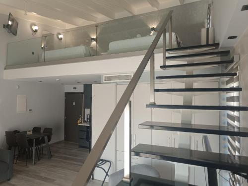 a staircase leading up to a room with a bunk bed at Oikos 9 Rooms and Suites in Nafpaktos