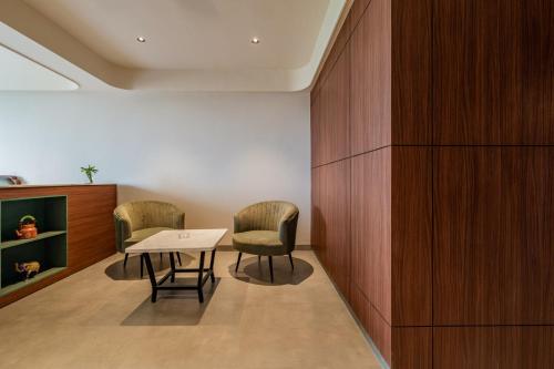 a room with two chairs and a table in it at Hotel Highway King Neemrana in Neemrana