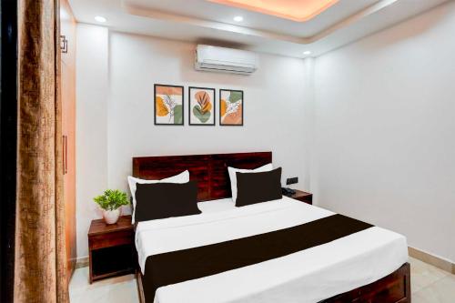 a bedroom with a black and white bed in a room at Collection O Sector 143B Noida in Noida