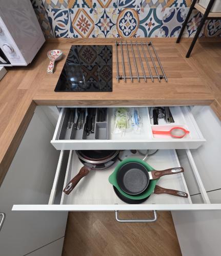 a shelf in a kitchen with a stove and utensils at B&B NewYork, Avellino in Avellino