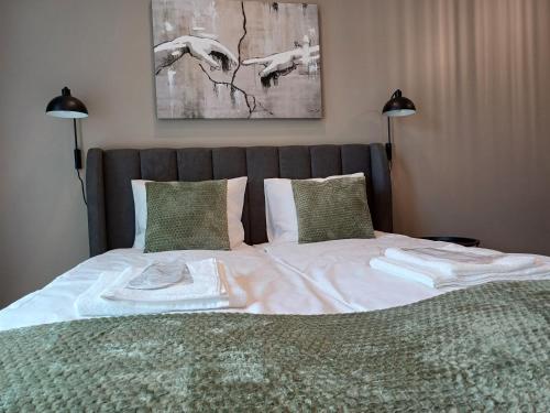 a bed with two towels on top of it at Luise LuXe Suites in Tallinn