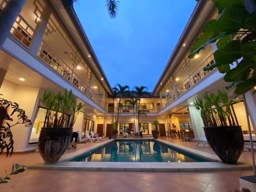 a large building with a swimming pool in the middle at The Elite Resort Pattaya in Pattaya South