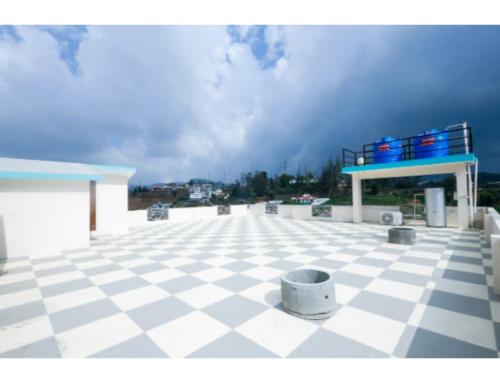 a gas station with a checkered floor at Cozy Heaven in Ooty