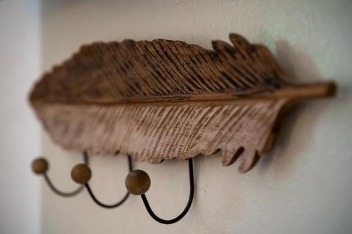 a wooden object is hanging on a wall at SKYROS AVRA Residences in Skiros