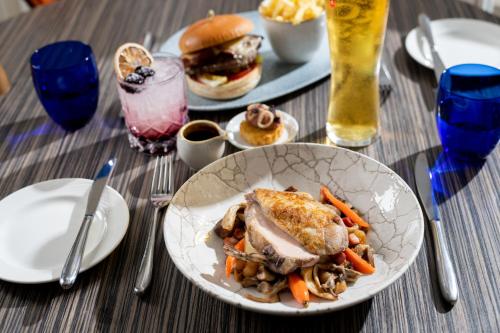 a table with a plate of food on a table at Harbour Hotel & Spa Christchurch in Christchurch
