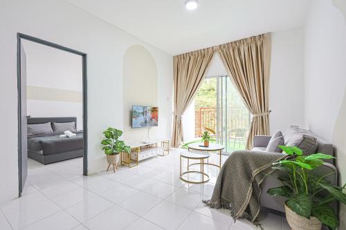 a living room with a couch and a table with plants at Cool Climate Comfort Cameron Highlands Holiday Clover Home 4-27 in Brinchang