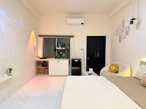 a white room with a bed and a couch at Four P Home - Binh Thanh in Ho Chi Minh City