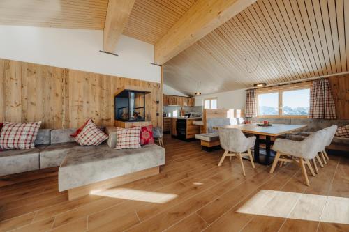 a living room with a couch and a table at Sonna Hüsli Lodge in Tschagguns