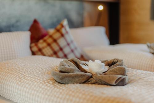 a towel on top of a bed with at Sonna Hüsli Lodge in Tschagguns