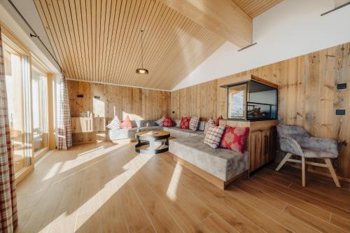 a living room with a couch and a table at Sonna Hüsli Lodge in Tschagguns