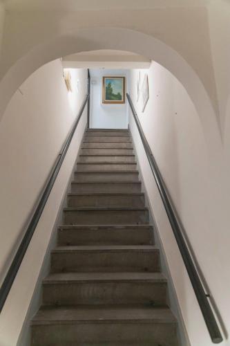 a flight of stairs in a building with a painting on the wall at Affittacamere Zanobi 45 in Florence