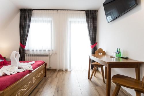 Postel nebo postele na pokoji v ubytování U Gawlaka - Noclegi z Jacuzzi i widokiem na Tatry