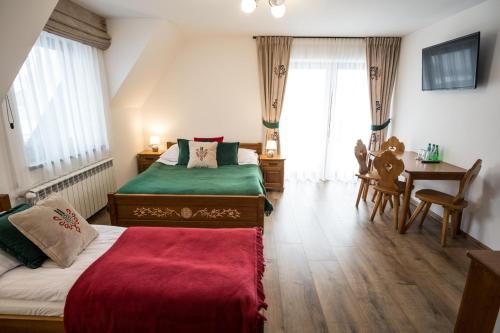 Postel nebo postele na pokoji v ubytování U Gawlaka - Noclegi z Jacuzzi i widokiem na Tatry