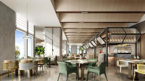 a restaurant with tables and chairs and tablesktop at Holiday Inn Changchun High Tech Zone by IHG in Changchun