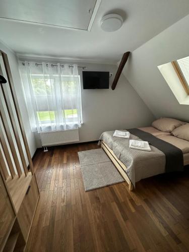 a small bedroom with a bed and a window at Hostel nad Drwęcą in Nowe Miasto Lubawskie