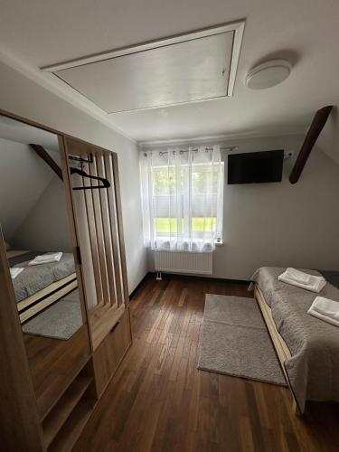a room with two bunk beds and a window at Hostel nad Drwęcą in Nowe Miasto Lubawskie