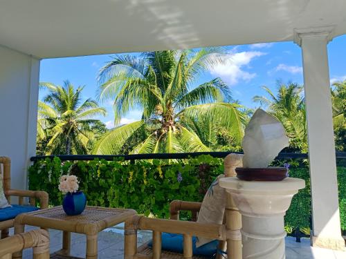 a balcony with a view of a palm tree at Skylodge B&B - Bali Jungle Retreat with Fine Dining & Eco Pool in Bukti
