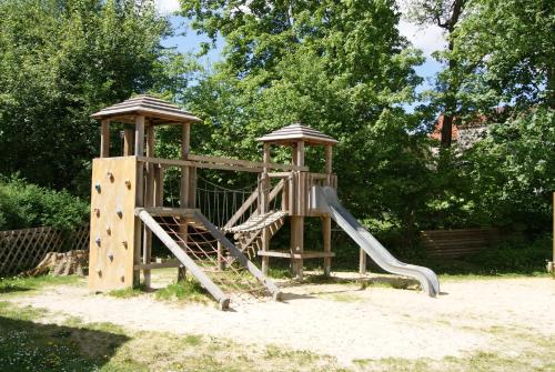 a playground with a slide and two gazebos at Hotel Braunlage in Braunlage