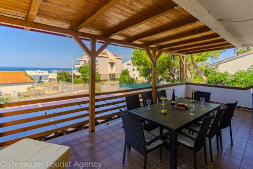 a table and chairs on the balcony of a house at Gato in Novalja