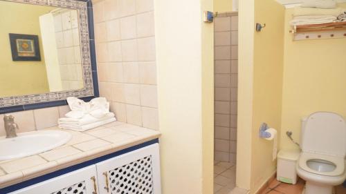 a bathroom with a sink and a toilet at La Molina Casa in Calera
