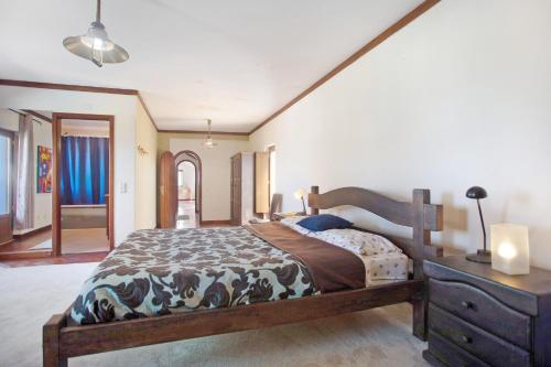 a bedroom with a large bed and a dresser at Melquites Country House in Barrantes