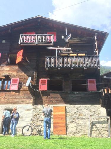 a group of people standing in front of a building at Chalet Bernadette in Mörel