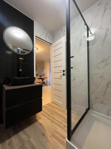 a bathroom with a shower and a sink at Gemini Lux - Sun Balaton in Balatonkenese