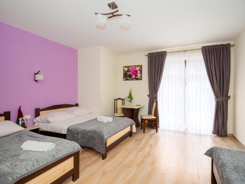 a hotel room with two beds and a window at U Kasi in Male Ciche