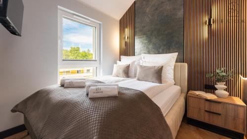 Postel nebo postele na pokoji v ubytování Jantar Resort Flatbook - Wynajem Apartamentów nad Morzem