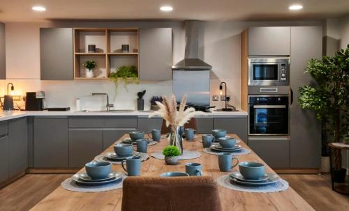 a kitchen with a table with blue dishes on it at For Students Only York House Nottingham in Nottingham