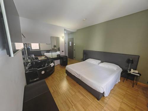 a bedroom with a bed and a bathroom with a sink at Smart Hotel in Carpi