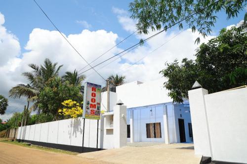 a white building with a sign in front of it at The Dream Rooms & Hottels in Puttalam