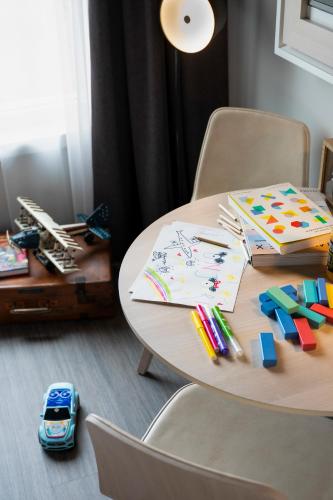 a wooden table with stationery on top of it at INNSiDE by Meliá Paris Charles de Gaulle Airport in Roissy-en-France