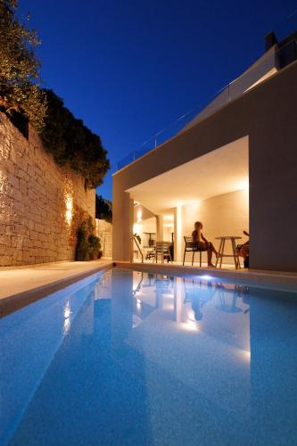 a villa with a swimming pool at night at Maradiva View in Villasimius