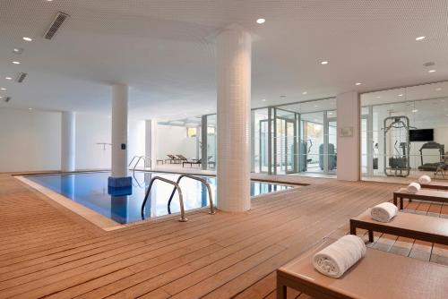 a room with a pool in the middle of a building at Meliá Calviá Beach in Magaluf