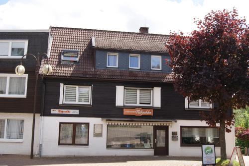a black and white building on a street at Hotel Braunlage in Braunlage